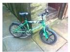 2x boys bikes. large green solid bike with stablizers, ....